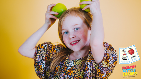 girl holding apple 