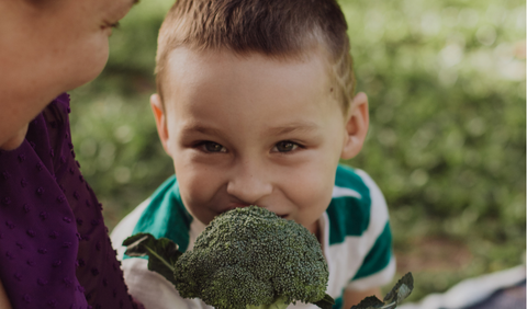 child eating broccoli. Child eating vegetables. Mum and child eating vegetables. 