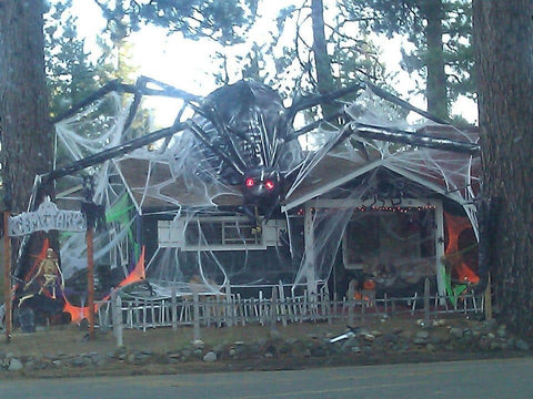 Home haunt with a giant spider decorated for Halloween