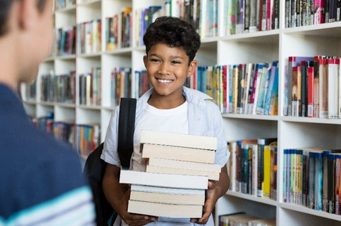 boy holding his books