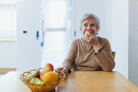 Mujer mayor comiendo fruta