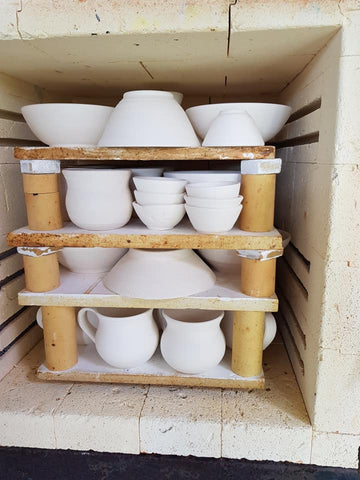 a kiln full of white pottery