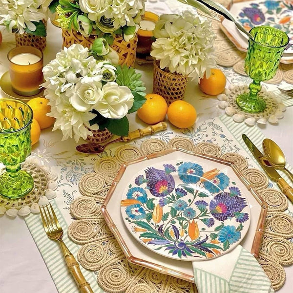 table settings with handwoven placemat with green tablecloth and lemons