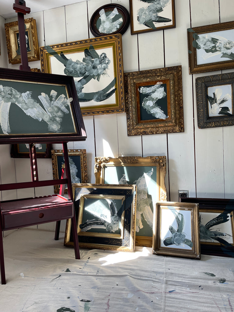 Christine Dore Trant abstract paintings with antique frames arranged in her studio