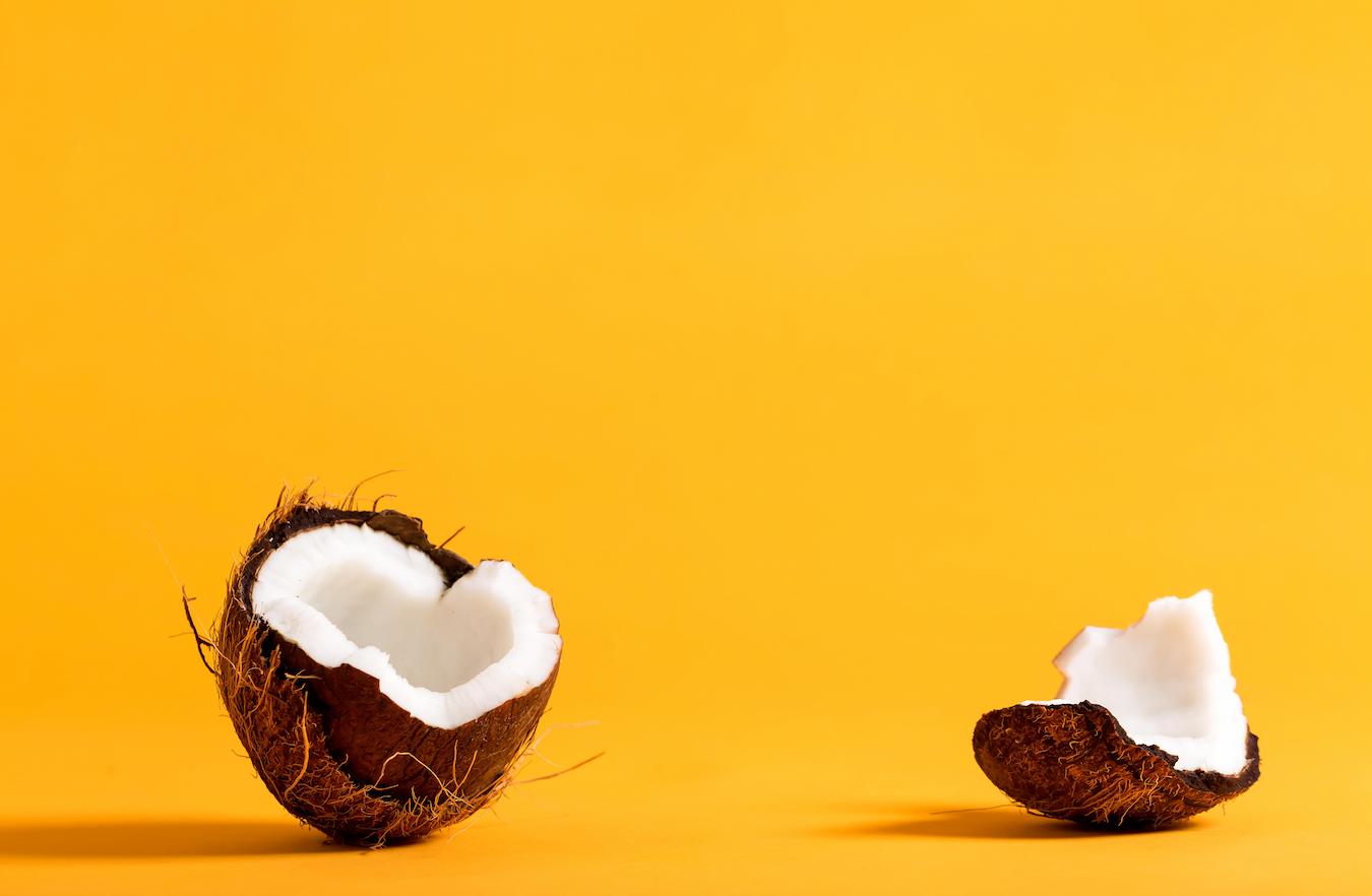a cut open coconut on a yellow background drug interactions mother's milk drug interactions mother's milk drug interactions clinical studies enough monolaurin test tubes candida albicans fatty acid fatty acid immune system lauric acid