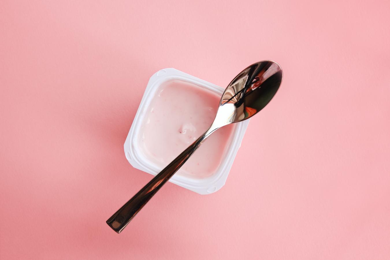 pink yogurt cup with a spoon artificial sweeteners probiotic supplements health benefits whole grains bowel movements processed foods