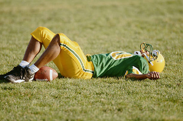 Football player lying on the field