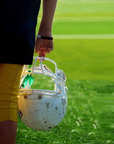football player holding helmet