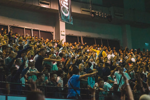 group of people cheering at a game