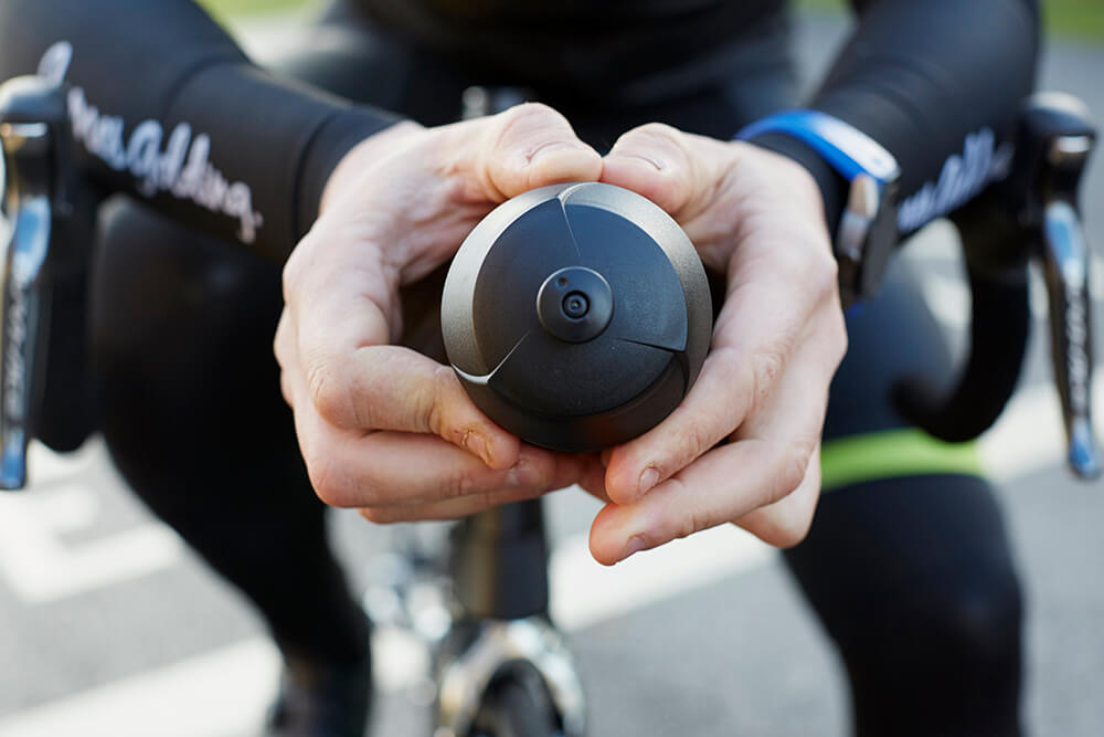 a cyclist holding a water bottle to fuel post-ride recovery