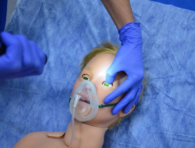 Arthur Paediatric Patient Simulator having its eyes examined