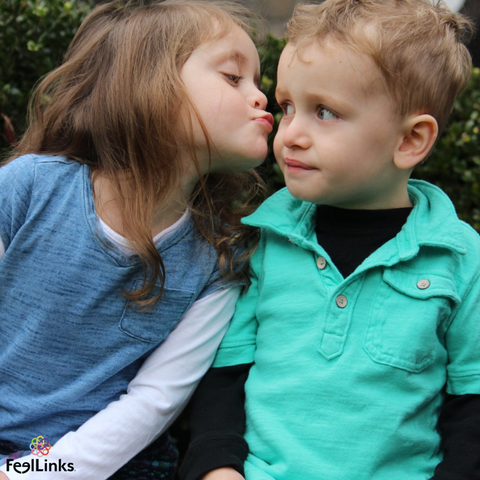 sad little brother with big sister kisses