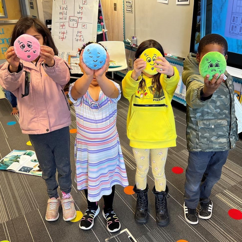 kids holding FeelLinks emotion dolls at school