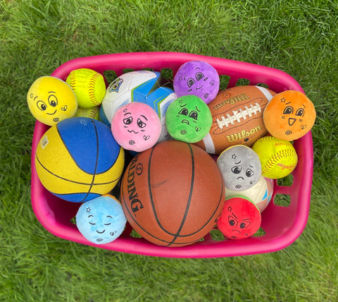 Bucket full of sports balls and FeelLinks dolls