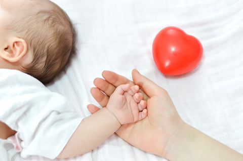 Mom holding her baby's hand