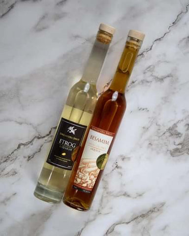 besamim and etrog liqueur bottles on a marble countertop