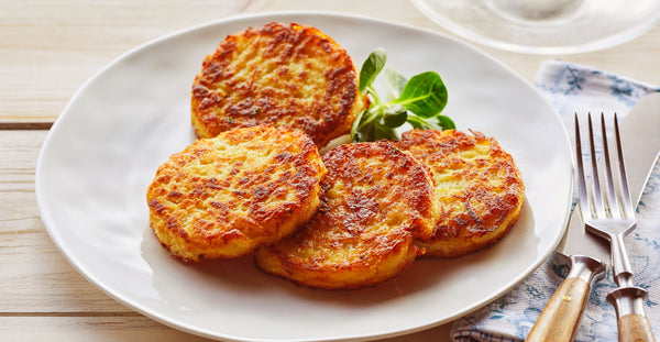 Kurman Communications: plate of crispy golden fried potato pancakes (latkes)