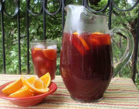 sangria in a pitcher with sliced fruit