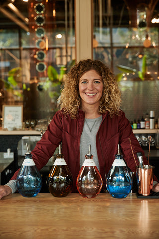 Jill Kuehler with Freeland Spirits bottles