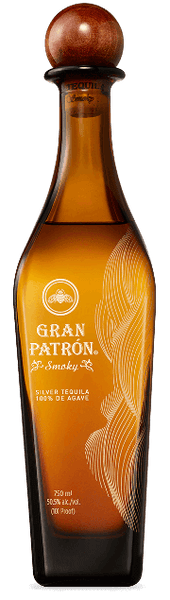 Tall thin light brown Gran Patron Smoky Tequila Bottle. Starts out dark and then lightens and widens slightly, tapering up with a big rounded bottle stopper.