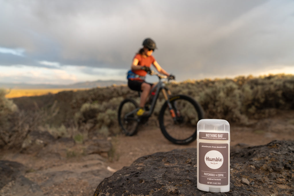 Person riding mountain bike behind Patchouli and Copal deodorant
