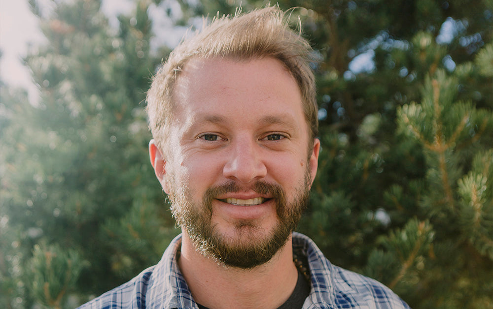 Man smiling with nature in the background