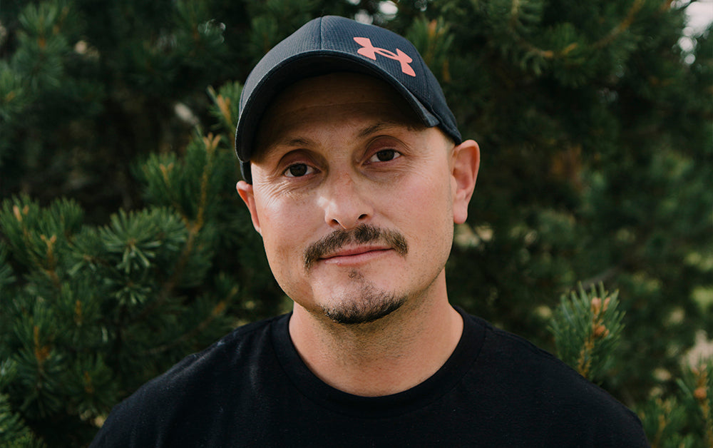 Man in baseball hat smiling