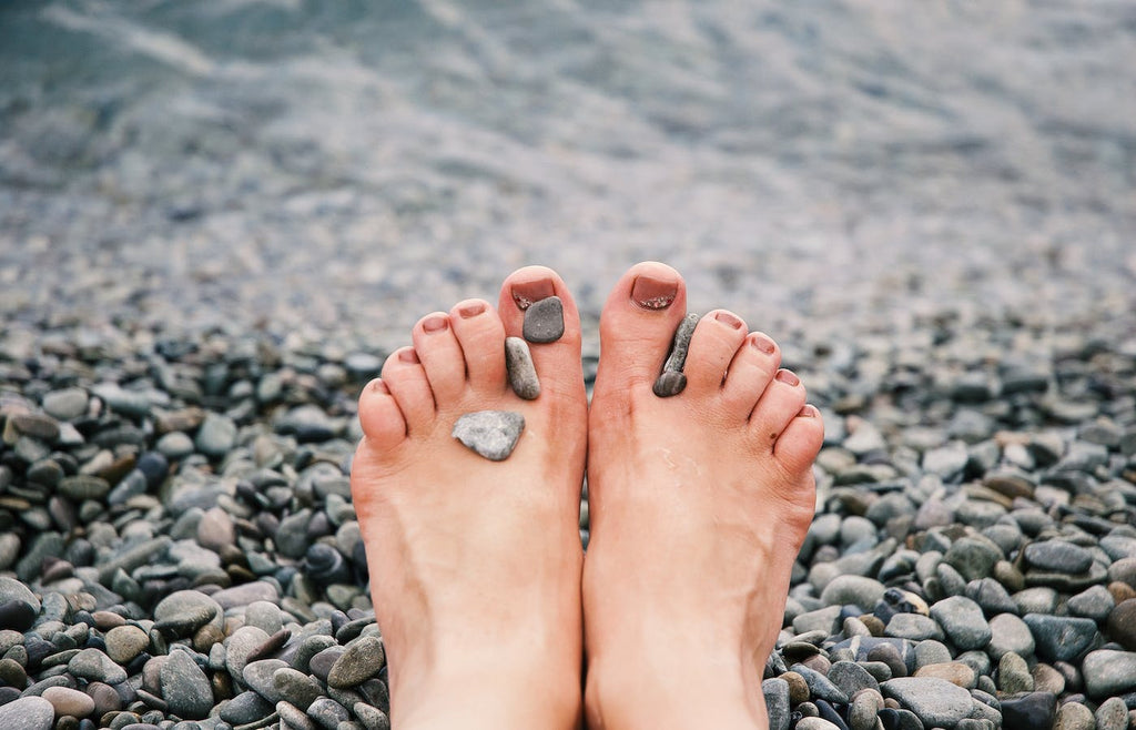 Toes on a rocky beach