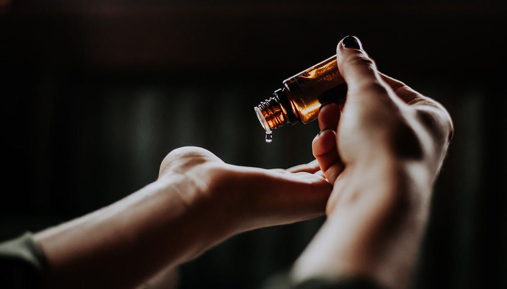 Drop of essential oil on hand