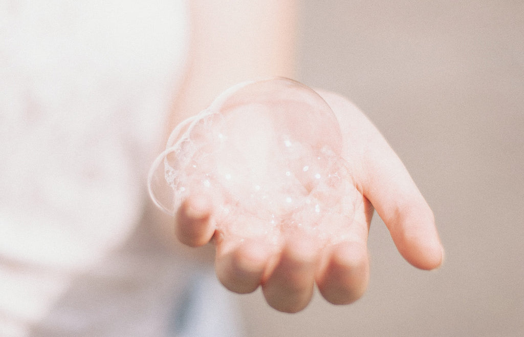 Close up of hand holding bubbles