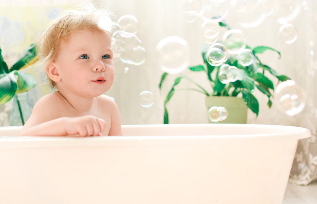 Baby in bathtub with bubbles