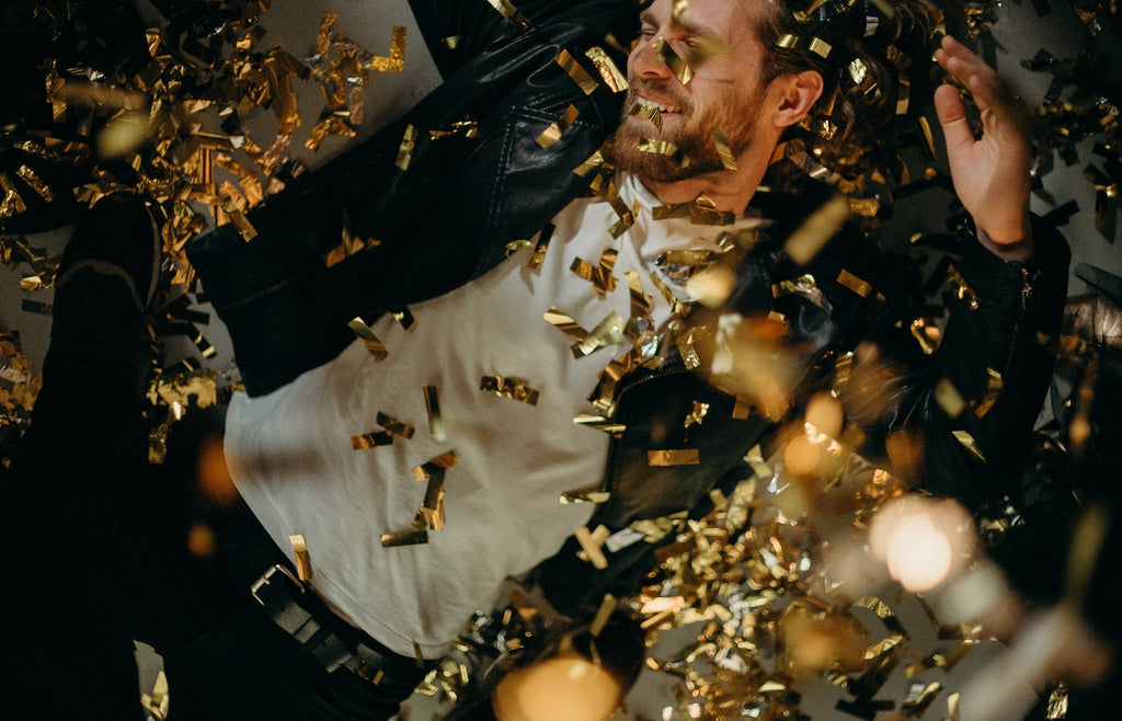Man with gold confetti all around