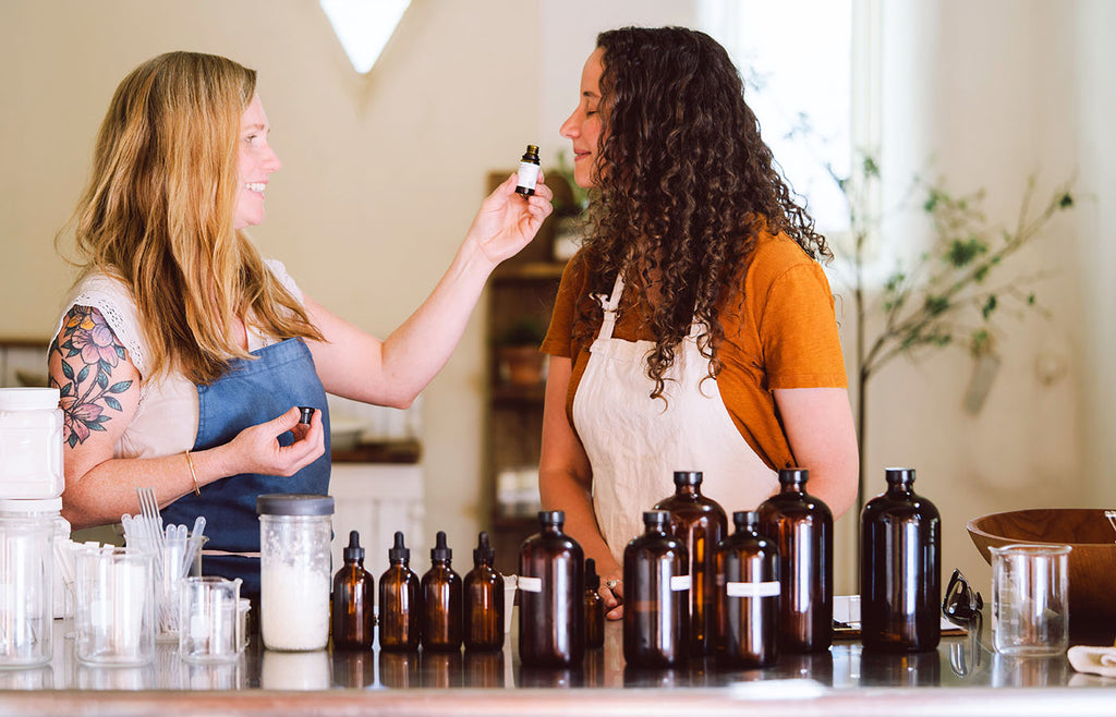 Two women working with scents one woman smelling scent