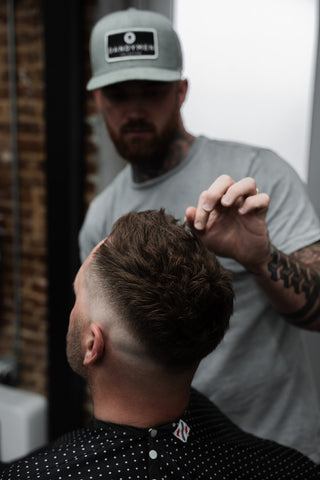 barber working on hair using dandymen products