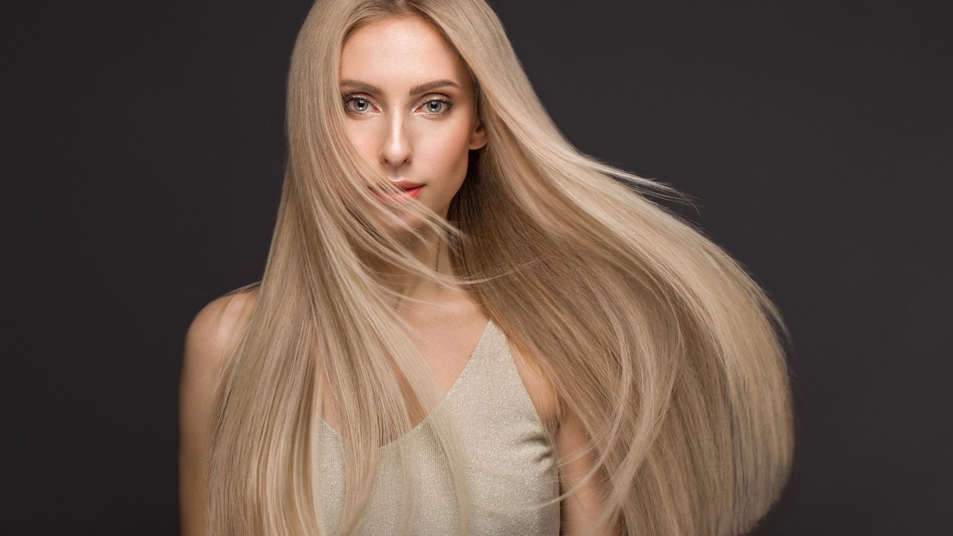woman wears flowing blonde hair extensions