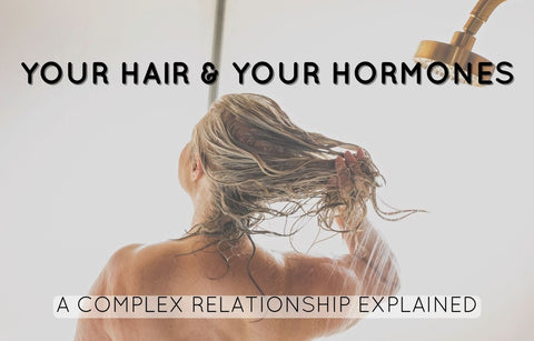 Your hair and your hormones: a complex relationship explained. Woman with grey hair washes her hair with House of Dear's shampoo and conditioner