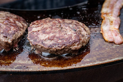 Wagyu burgers cooking on a grill