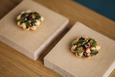 small canapes served on wooden boards