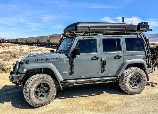 Jeep with a hard shell roof top tent