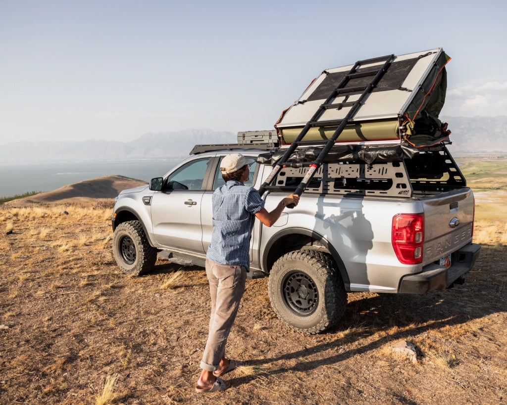 Man setting up a roof top tent