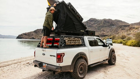 Man opening roam Desperado hard shell roof top tent