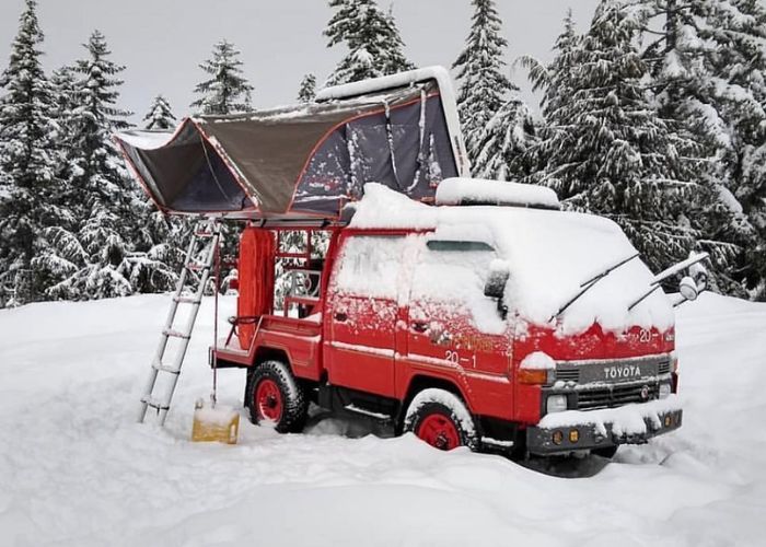 Roof top tent on a Red Toyota Truck