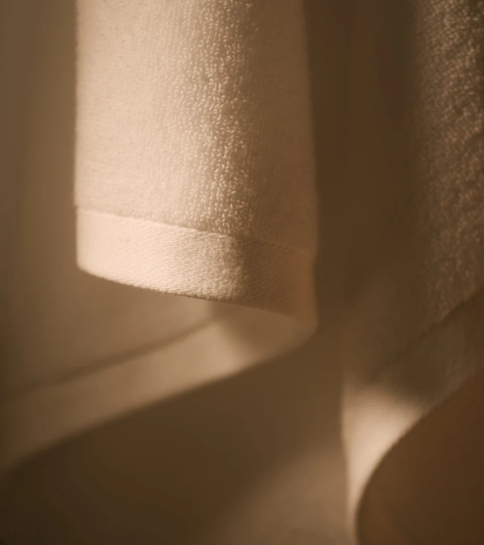 Soft white towel hanging in warm light