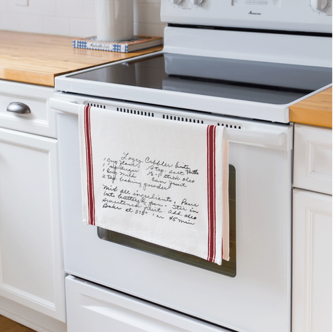 red stripe vintage tea towel hanging on oven handle in kitchen