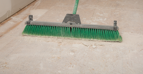 Subfloor being swept with brush 