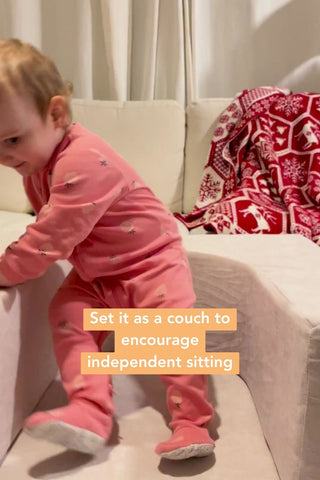 baby sitting down on a kids couch