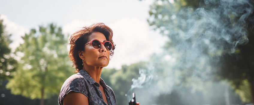 woman with cbd vape in a parc