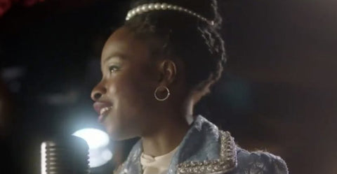 Amanda Gorman performing at the Superbowl wearing her pearl headband