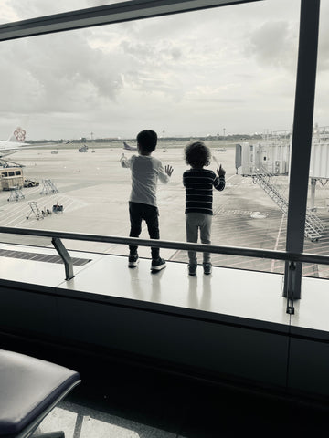 Toddlers at airport watching planes