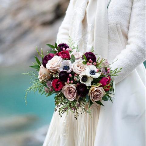 poinsettias anemones winter wedding bouquet red roses pink flowers cold weather flowers berries